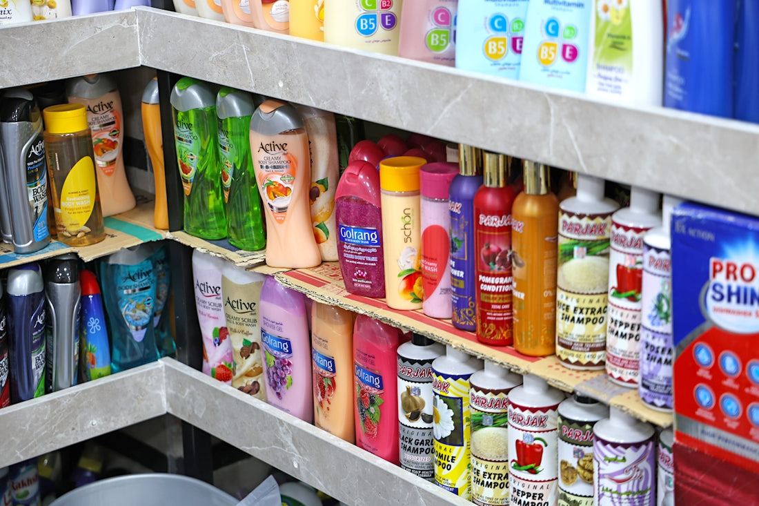 Shelves stocked with various bottles of shampoo and conditioner.